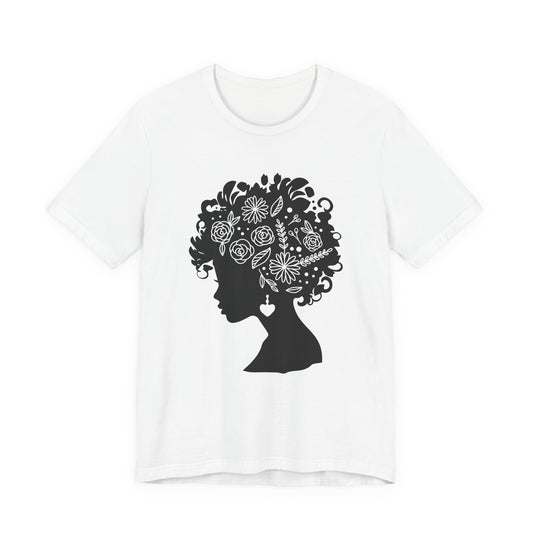 Black woman floral silhouette t-shirt worn by mature woman in blazer, lightweight cotton graphic tee with intricate natural hair floral design